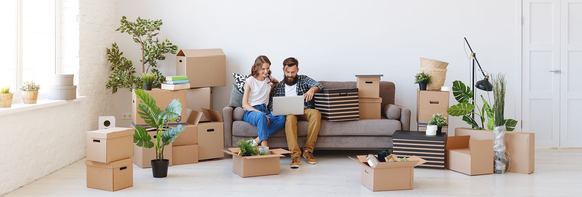happy young married couple moves to new apartment